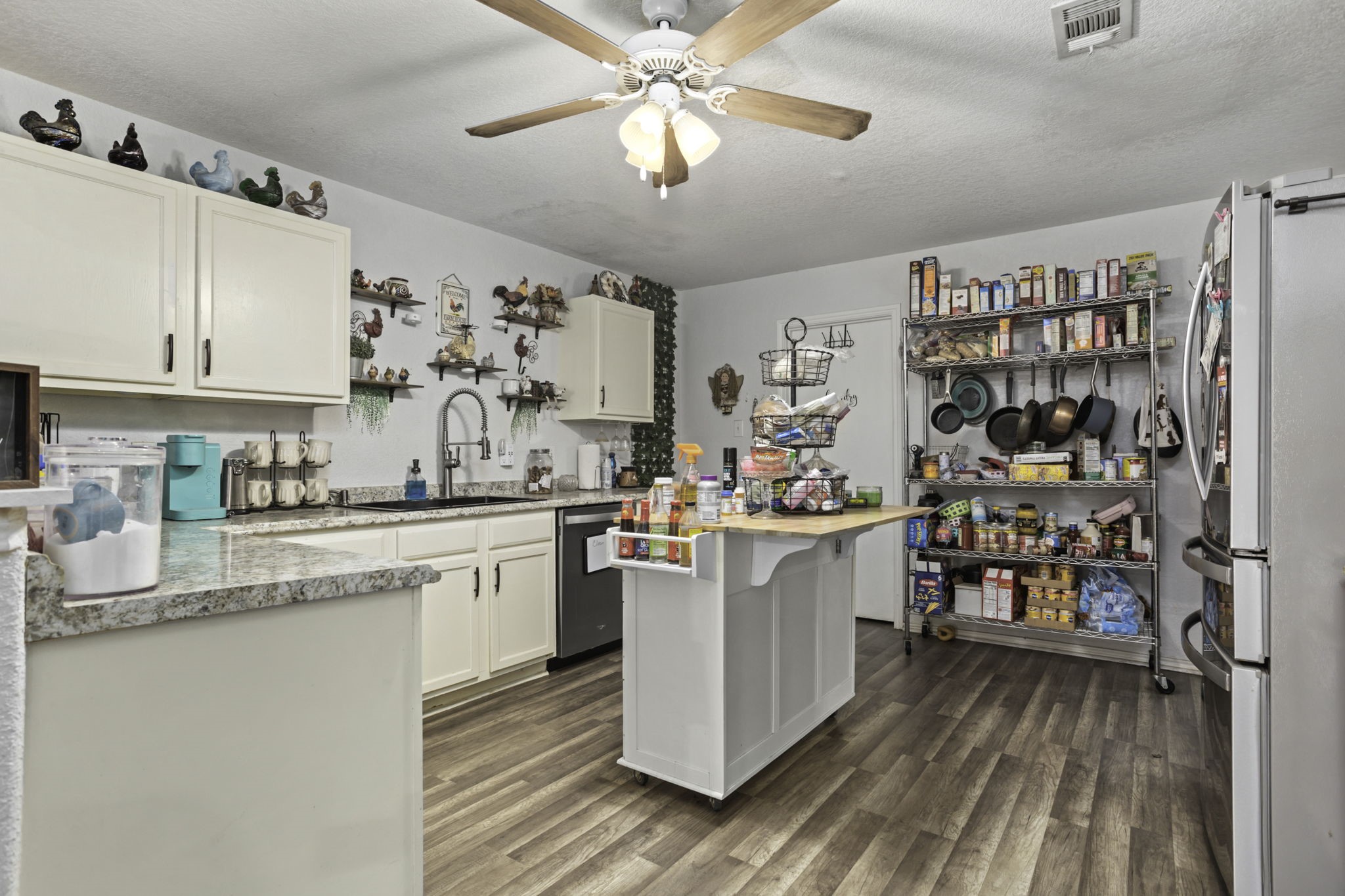 4518 Rothberger Way San Antonio, TX 78244 - Photo 8 of 18 a kitchen with a lot of cabinets and wooden floor