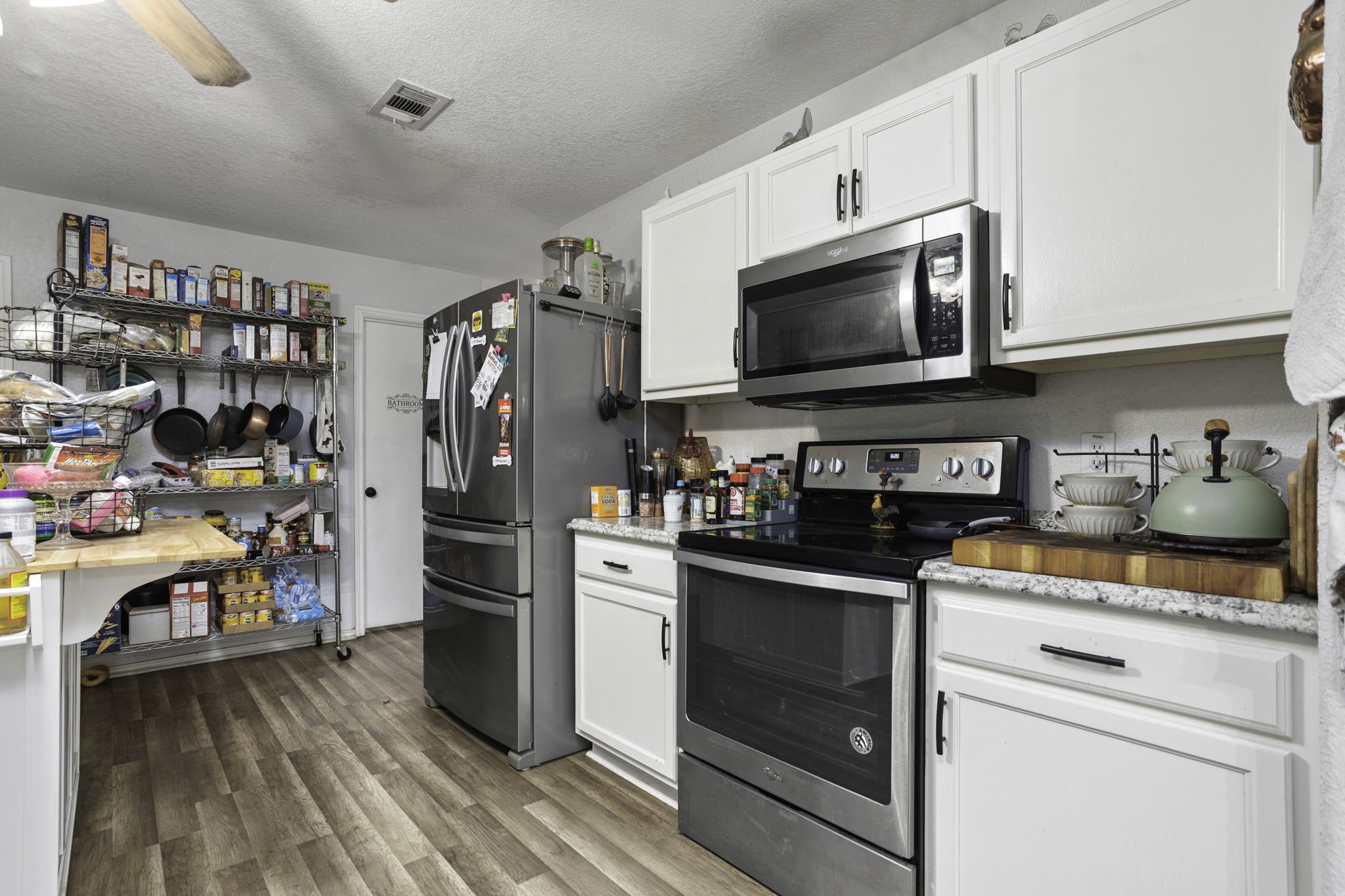 4518 Rothberger Way San Antonio, TX 78244 - Photo 10 of 18 a kitchen with stainless steel appliances a stove a microwave and a refrigerator