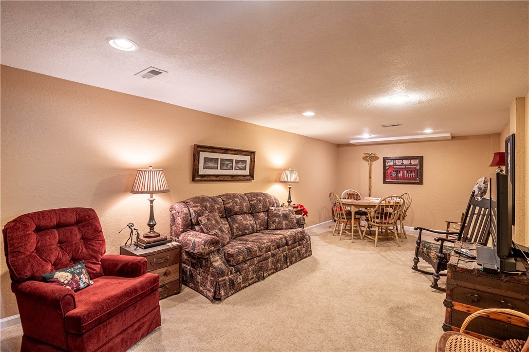 75 Ridgedale Drive Decatur, IL 62521 - Photo 20 of 26 a living room with furniture gym equipment and a flat screen tv