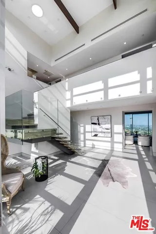 a bed sitting in a spacious bedroom next to a balcony