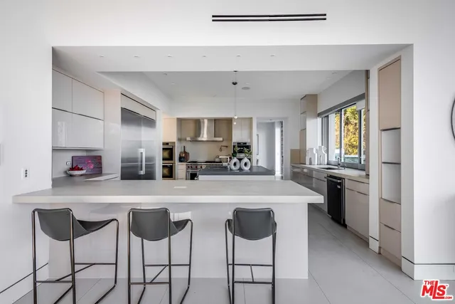a kitchen with stainless steel appliances a sink stove and refrigerator