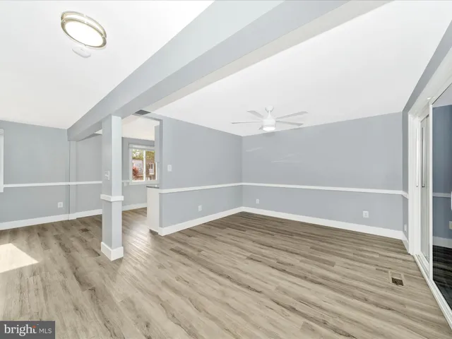 a kitchen with granite countertop a refrigerator and a stove top oven