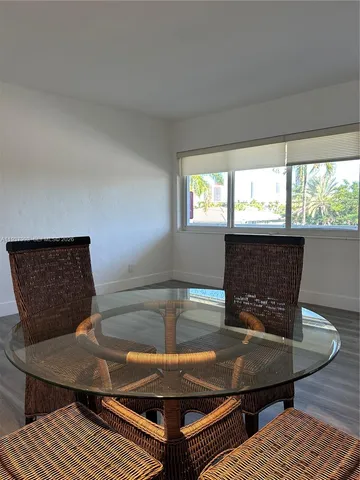 a view of a dining room with furniture and window