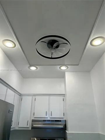 a view of staircase with white walls and a painting on the wall