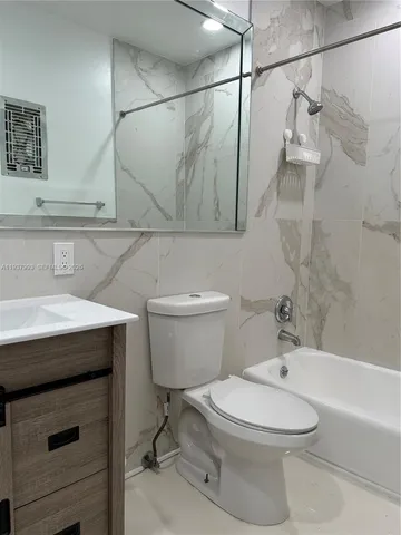 a bathroom with a toilet a sink and bathtub