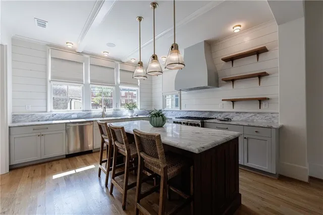 a kitchen with granite countertop a sink stove and cabinets