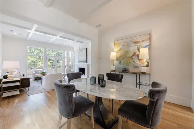 a living room with fireplace furniture and a large window