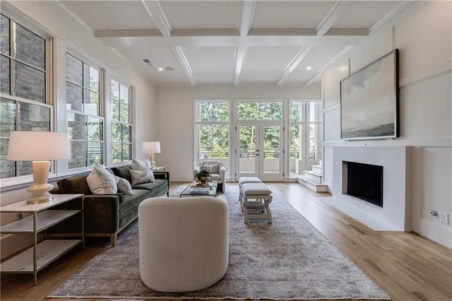 a living room with furniture and large windows