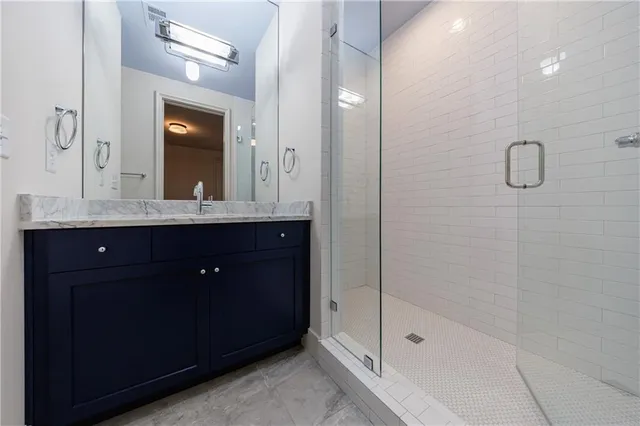 a kitchen with stainless steel appliances granite countertop a sink a stove and a refrigerator