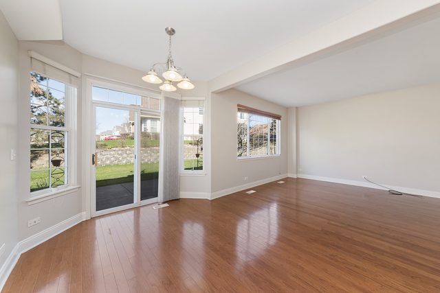 522 Telluride Court Bartlett, IL 60103 - Photo 5 of 18 a view of an empty room with wooden floor and a window
