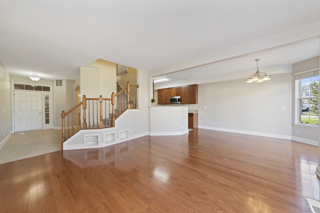 522 Telluride Court Bartlett, IL 60103 - Photo 8 of 18 a view of a livingroom with wooden floor and staircase