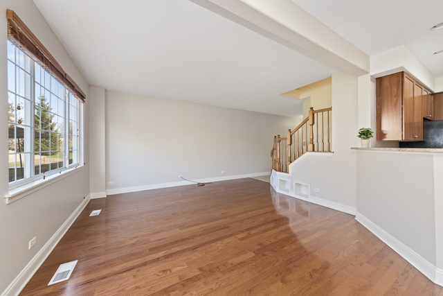522 Telluride Court Bartlett, IL 60103 - Photo 9 of 18 a view of a bedroom with wooden floor and a window