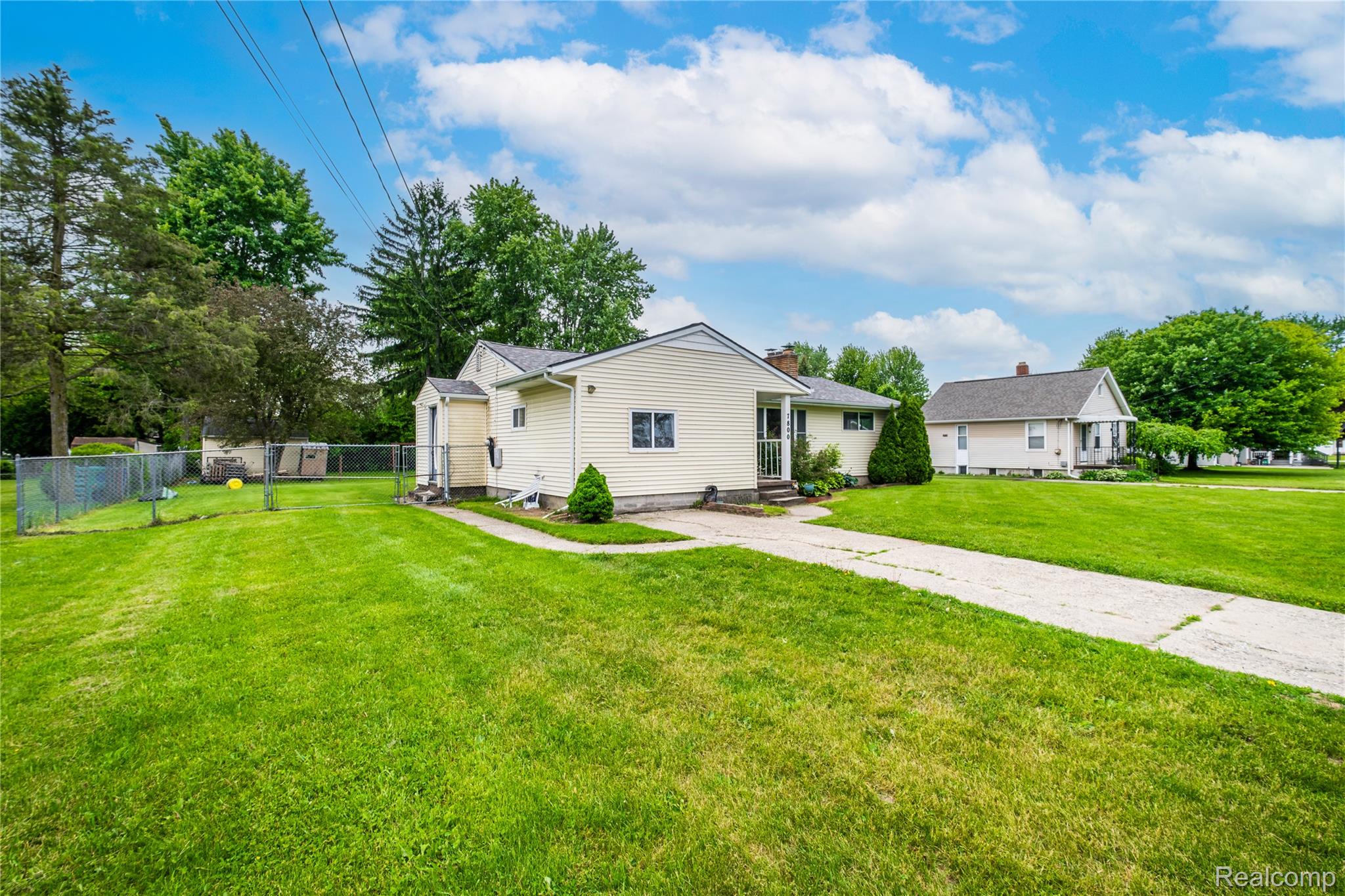 7800 Maple Street Birch Run, MI 48415 - Photo 21 of 29 Expansive lot featuring a single-story residence with light-colored siding, a concrete driveway, and mature landscaping