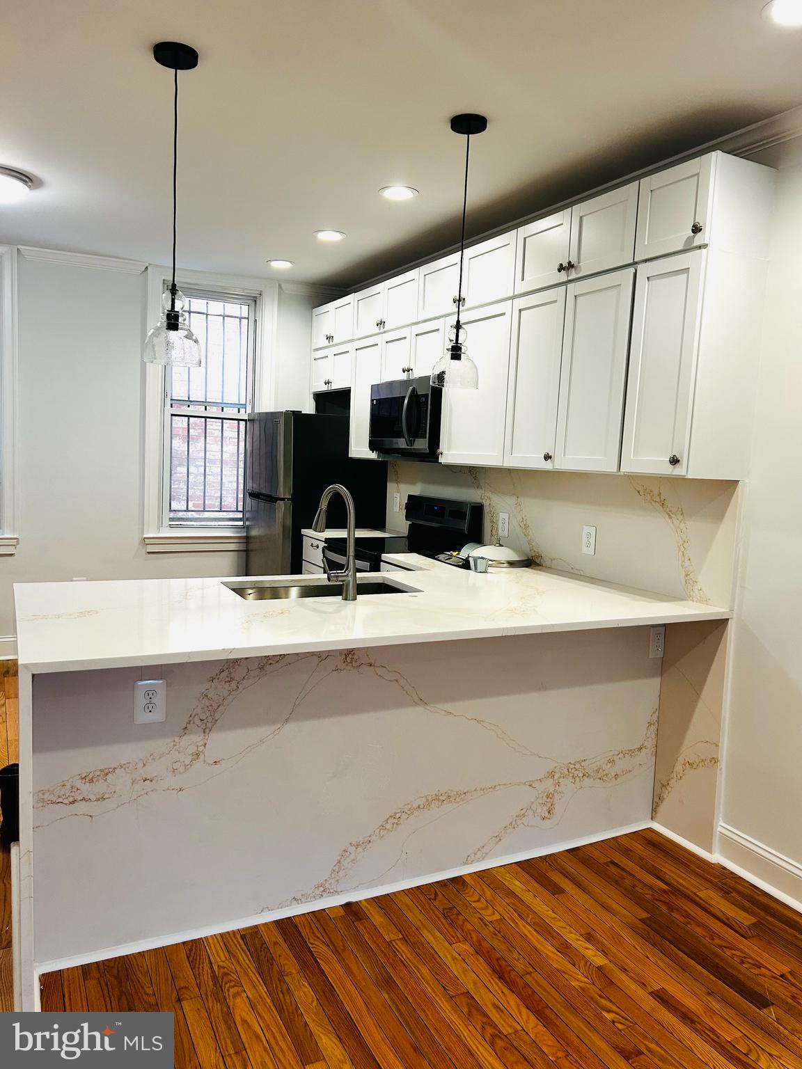 1724 18th Street Northwest, Unit 1 Washington, DC 20009 - Photo 3 of 11 a kitchen with a sink cabinets and window