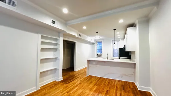 a large kitchen with kitchen island a sink stainless steel appliances and cabinets