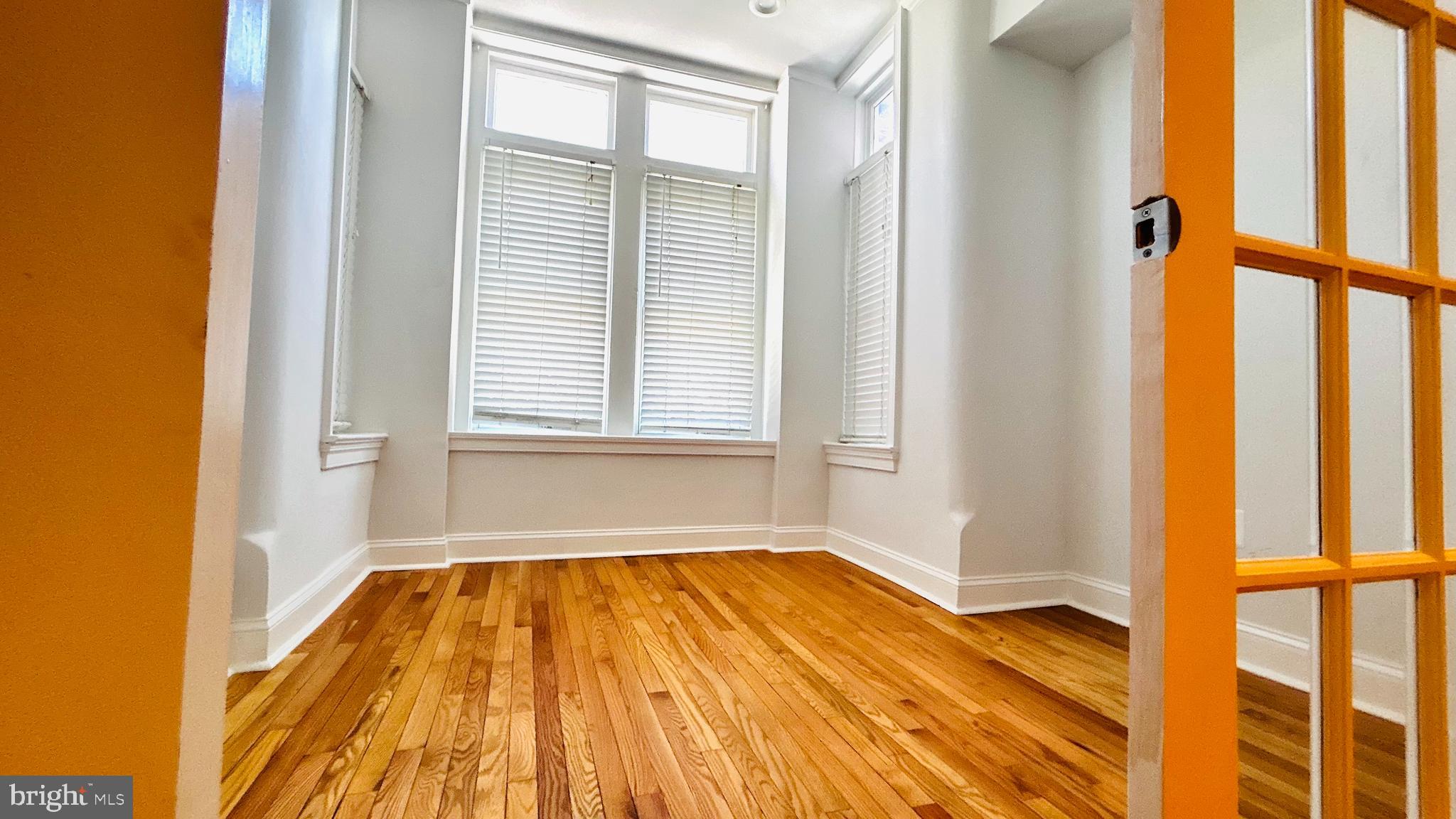 1724 18th Street Northwest, Unit 1 Washington, DC 20009 - Photo 7 of 11 a view of a room with wooden floor and windows