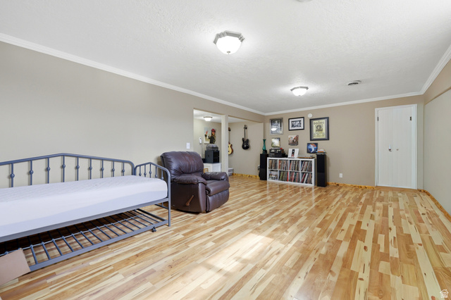 1486 3rd Street Ogden, UT 84404 - Photo 14 of 26 Bright living space featuring natural wood-finish flooring, neutral wall paint, and white crown molding