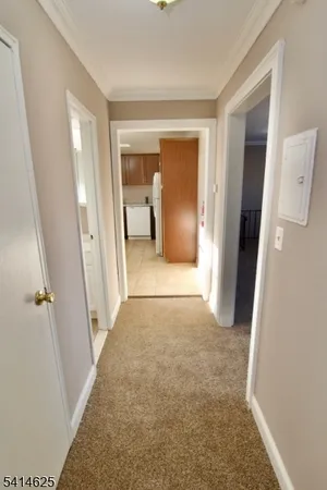 a view of a hallway to rooms
