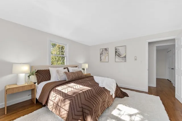 a bedroom with a bed and painting on the wall