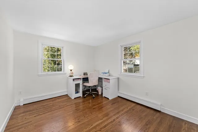 a view of a workspace with furniture and a window
