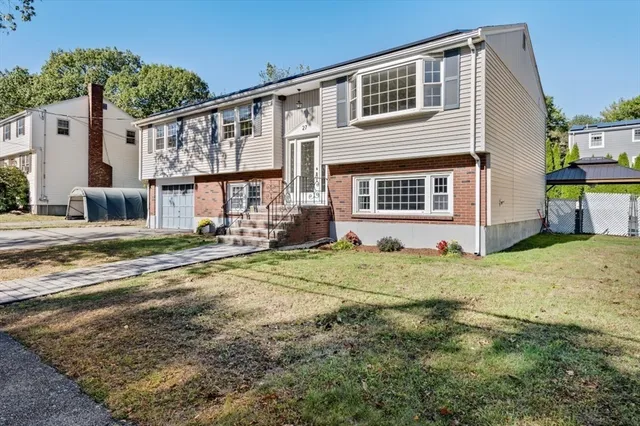 a view of a house with a backyard