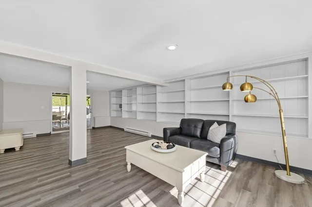 a living room with furniture and wooden floor