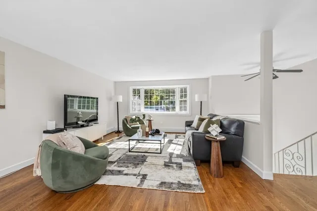 a living room with furniture window and wooden floor