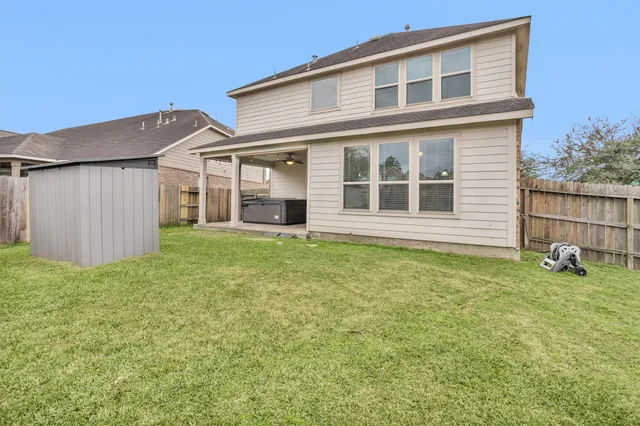 a view of a house with backyard and garden