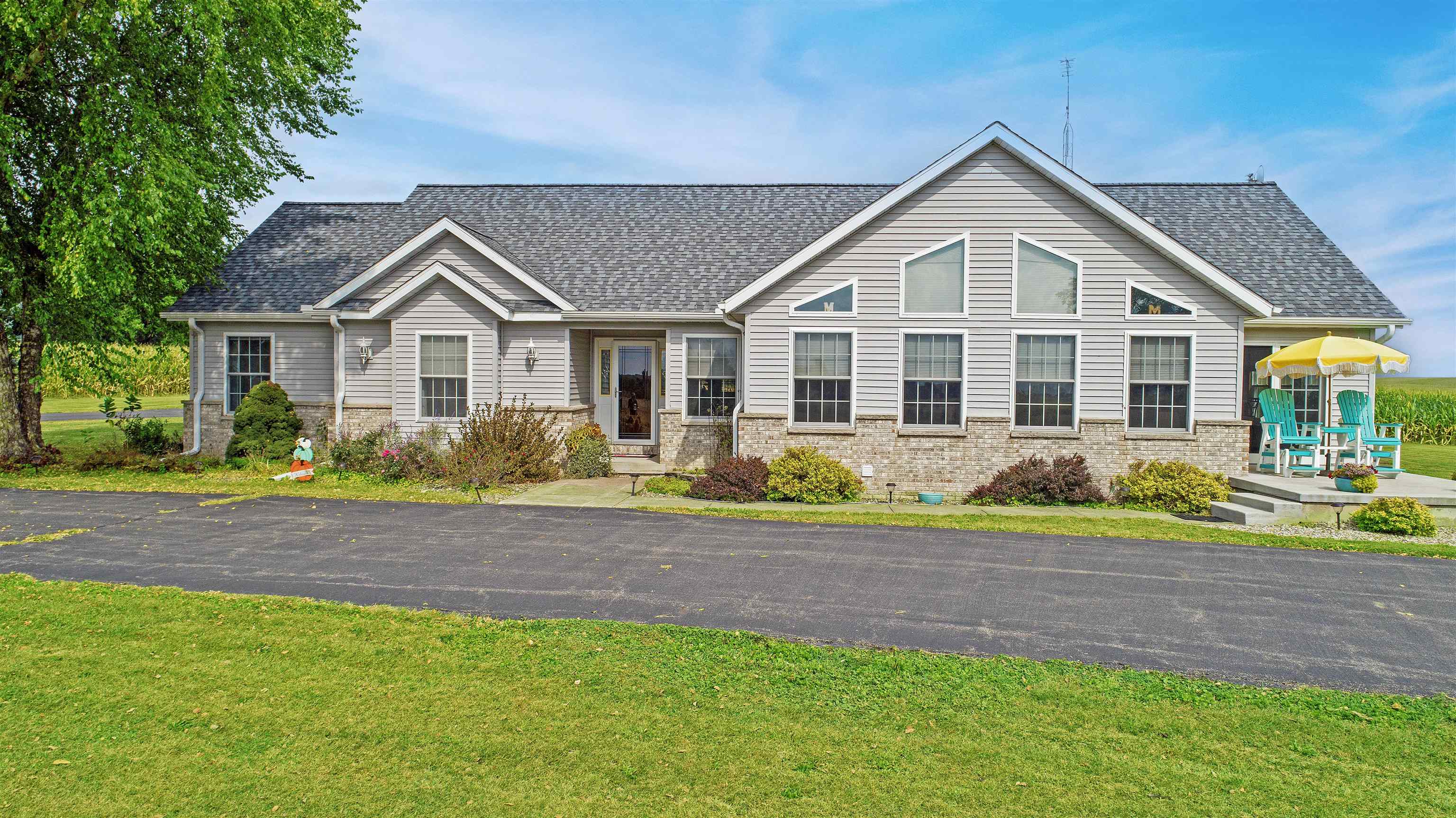 7821 Oakville Road Mount Carroll, IL 61053 - Photo 1 of 50 a front view of a house with a yard and potted plants