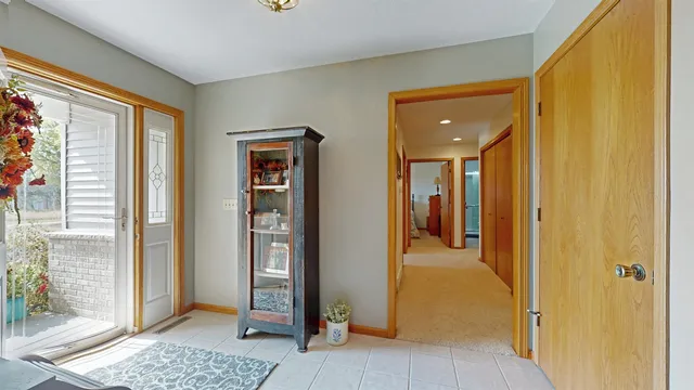 a view of a hallway with wooden floor and a bedroom