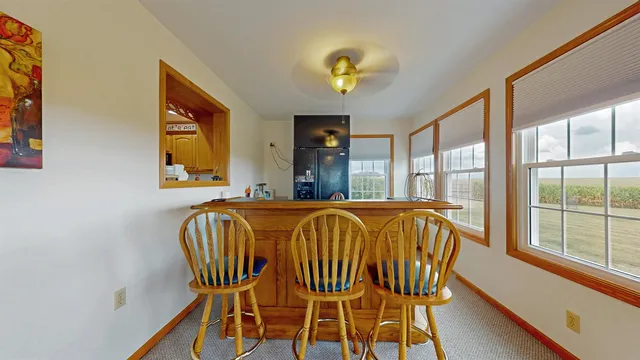 a view of a dining room with furniture and a chandelier