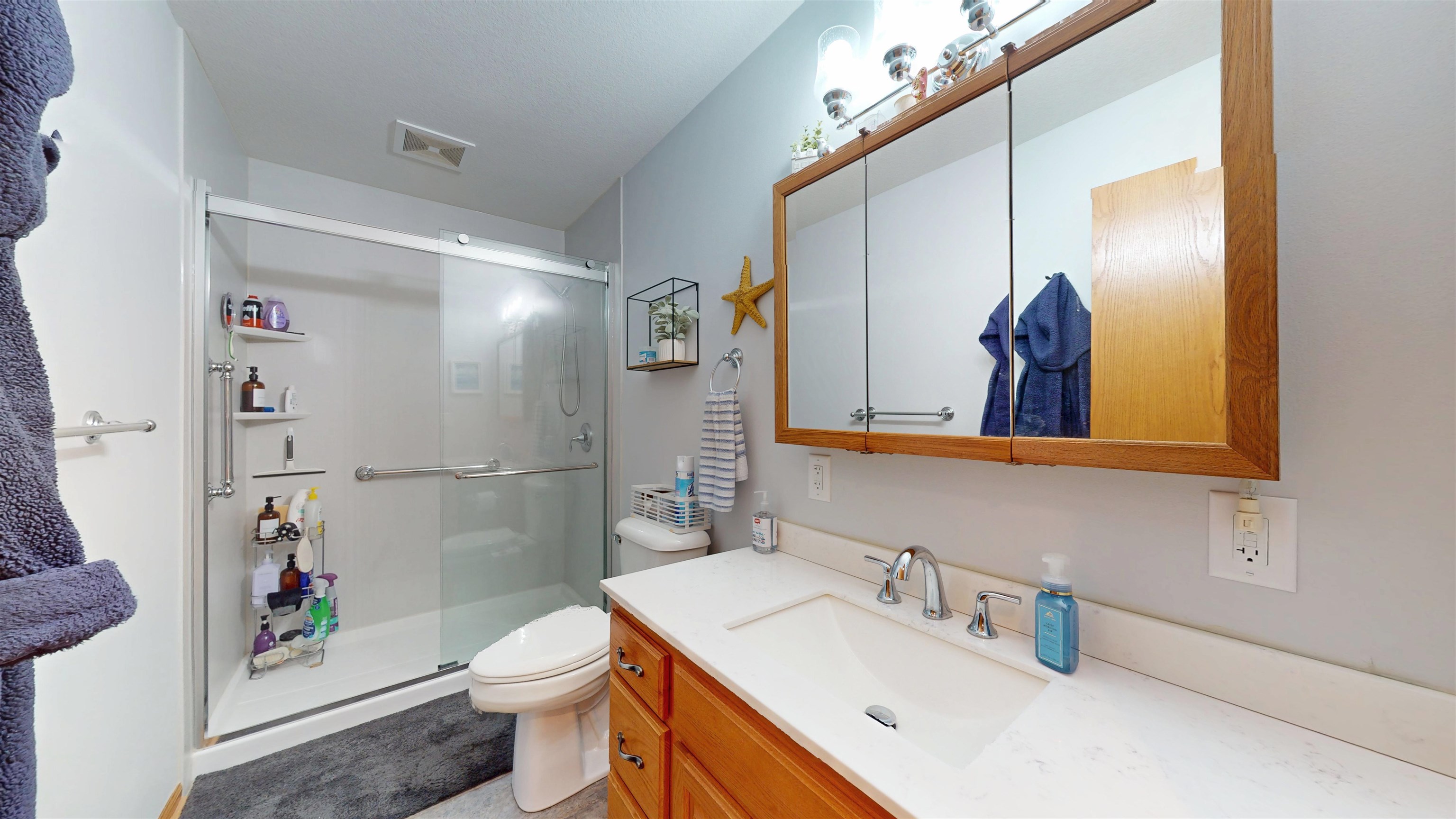 7821 Oakville Road Mount Carroll, IL 61053 - Photo 26 of 50 a bathroom with a sink a toilet and shower