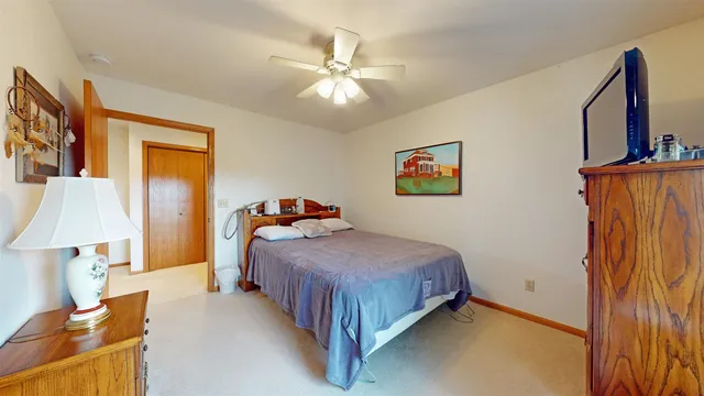 a bedroom with a bed and a lamp on table