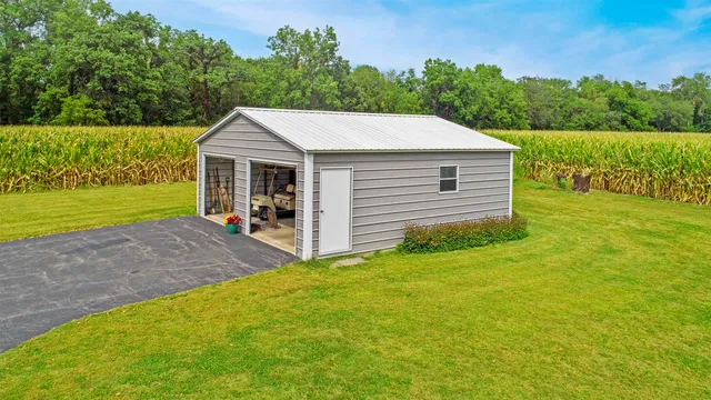 a view of a house with a yard and sitting area