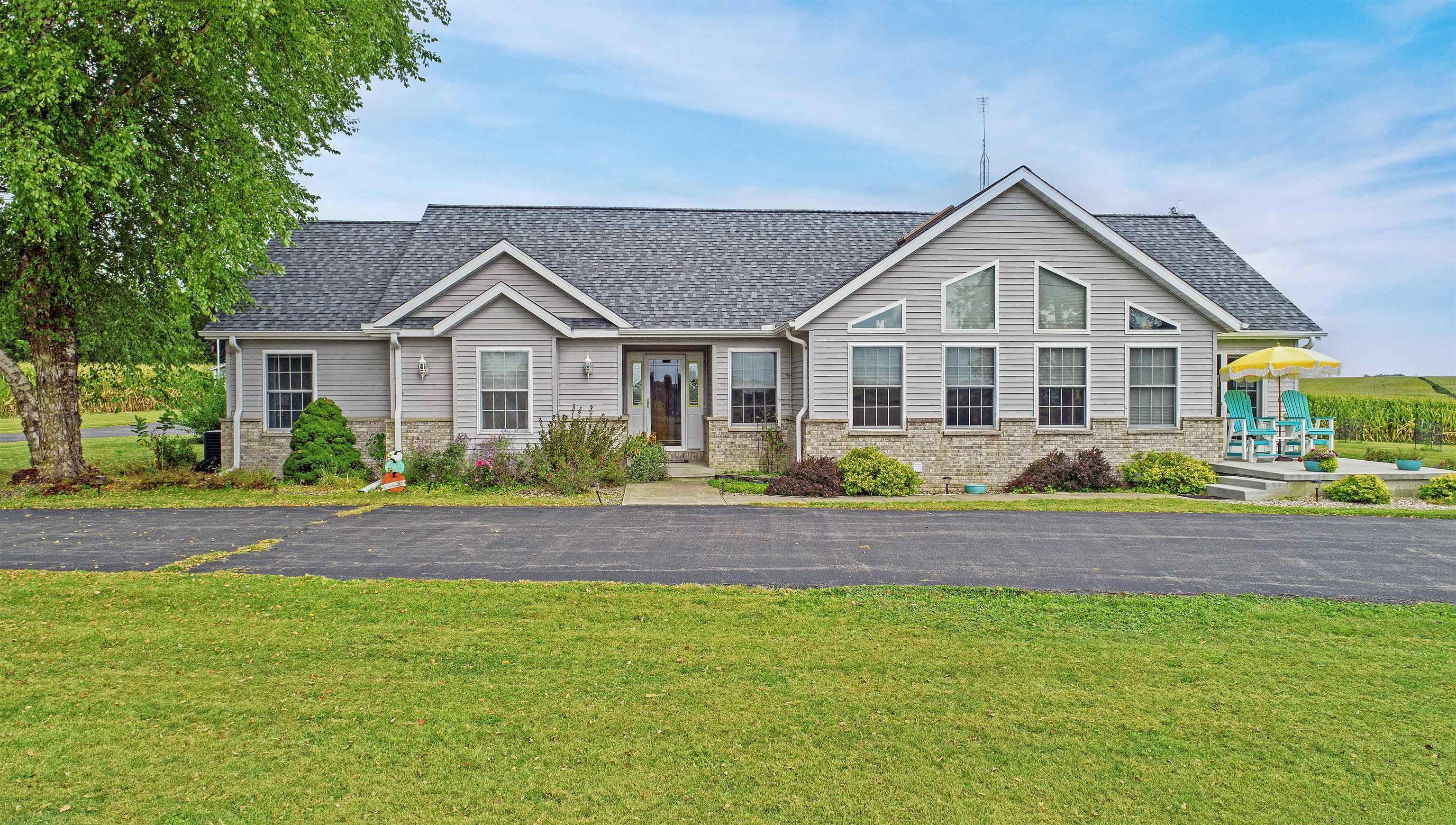 7821 Oakville Road Mount Carroll, IL 61053 - Photo 34 of 50 a front view of a house with a garden