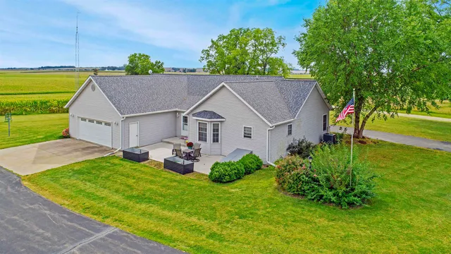 a view of a house with a yard and potted plants