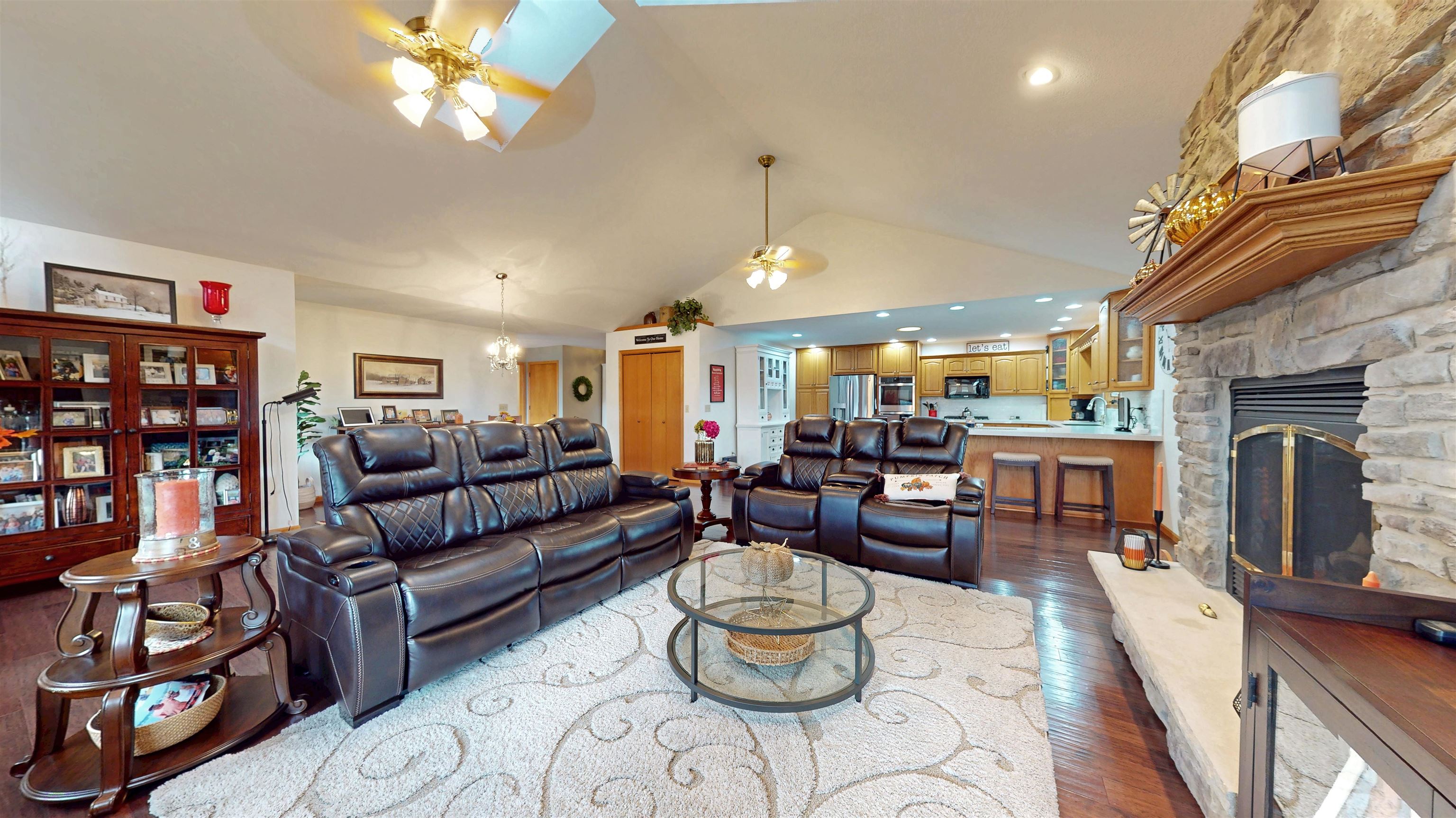 7821 Oakville Road Mount Carroll, IL 61053 - Photo 5 of 50 a living room with furniture a fireplace and a chandelier
