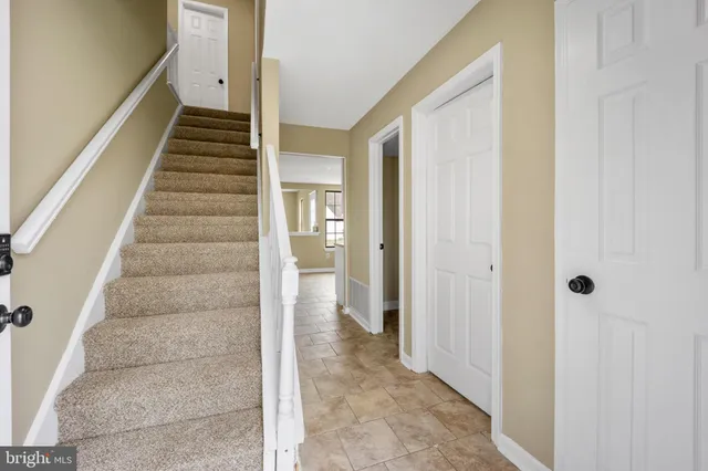 a view of a hallway with wooden floor and entryway