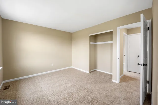 a view of a house with a backyard and a tree