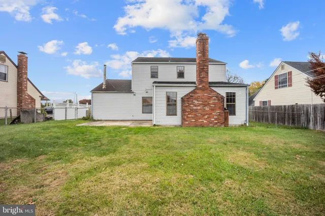 a view of yard with swimming pool and trees in the background