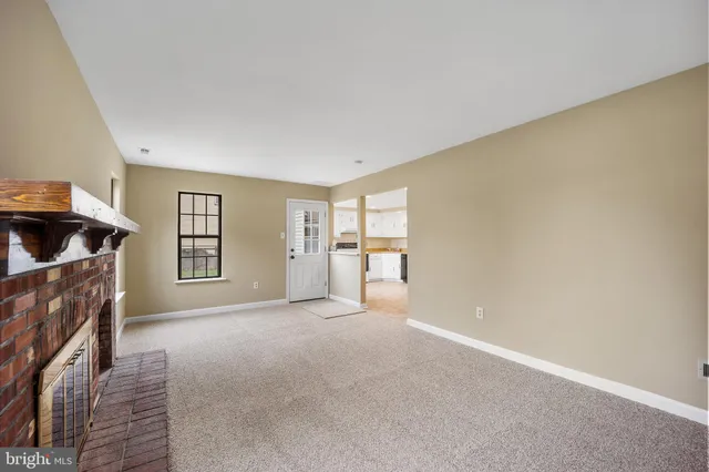a view of empty room with a fireplace