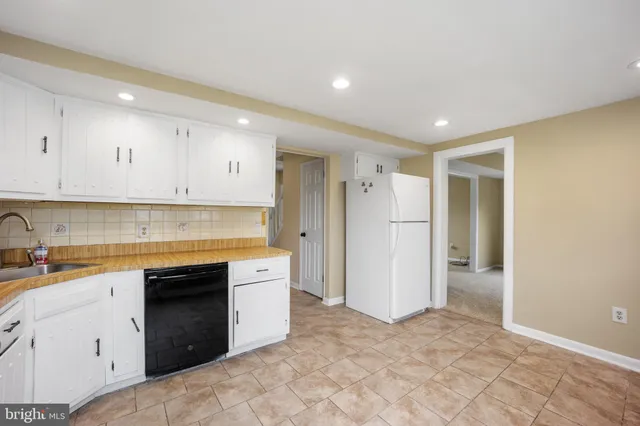 a kitchen with a sink stove and refrigerator
