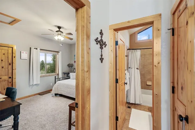 a spacious bedroom with a bed and a window