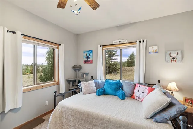 a bedroom with a large bed and a window