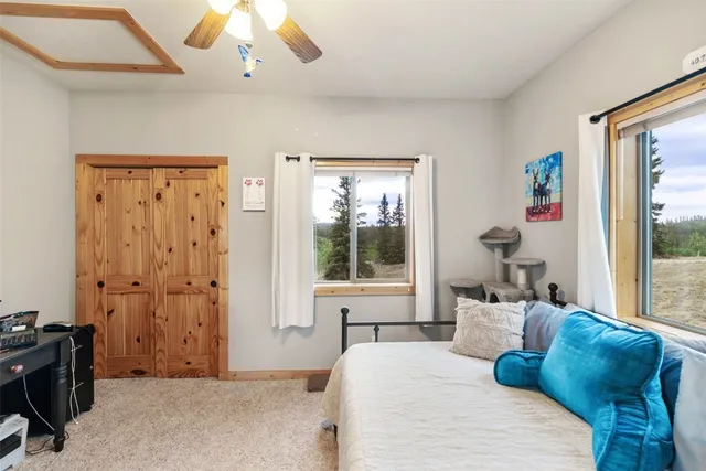 a bedroom with a large bed and a window