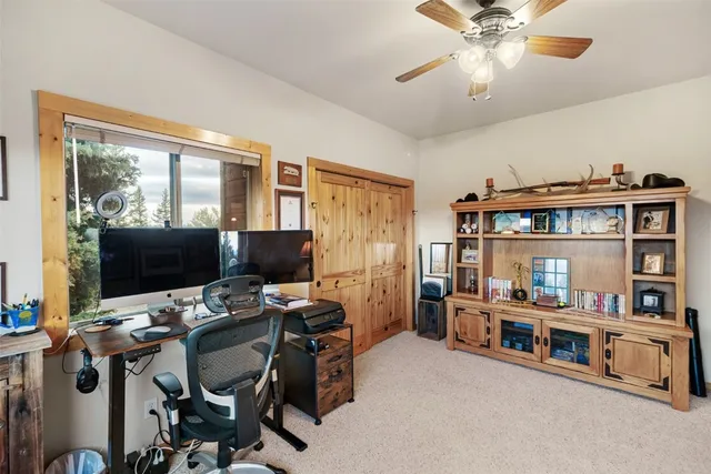 a work room with furniture and a flat screen tv