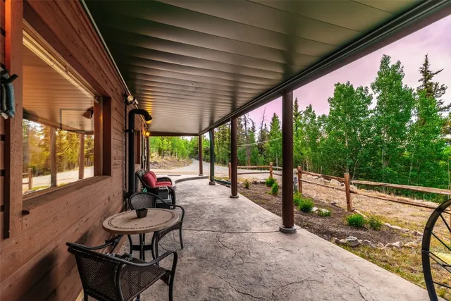 a view of a patio with a table chairs and a backyard