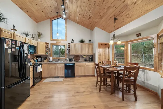 a kitchen with a table chairs stove and refrigerator