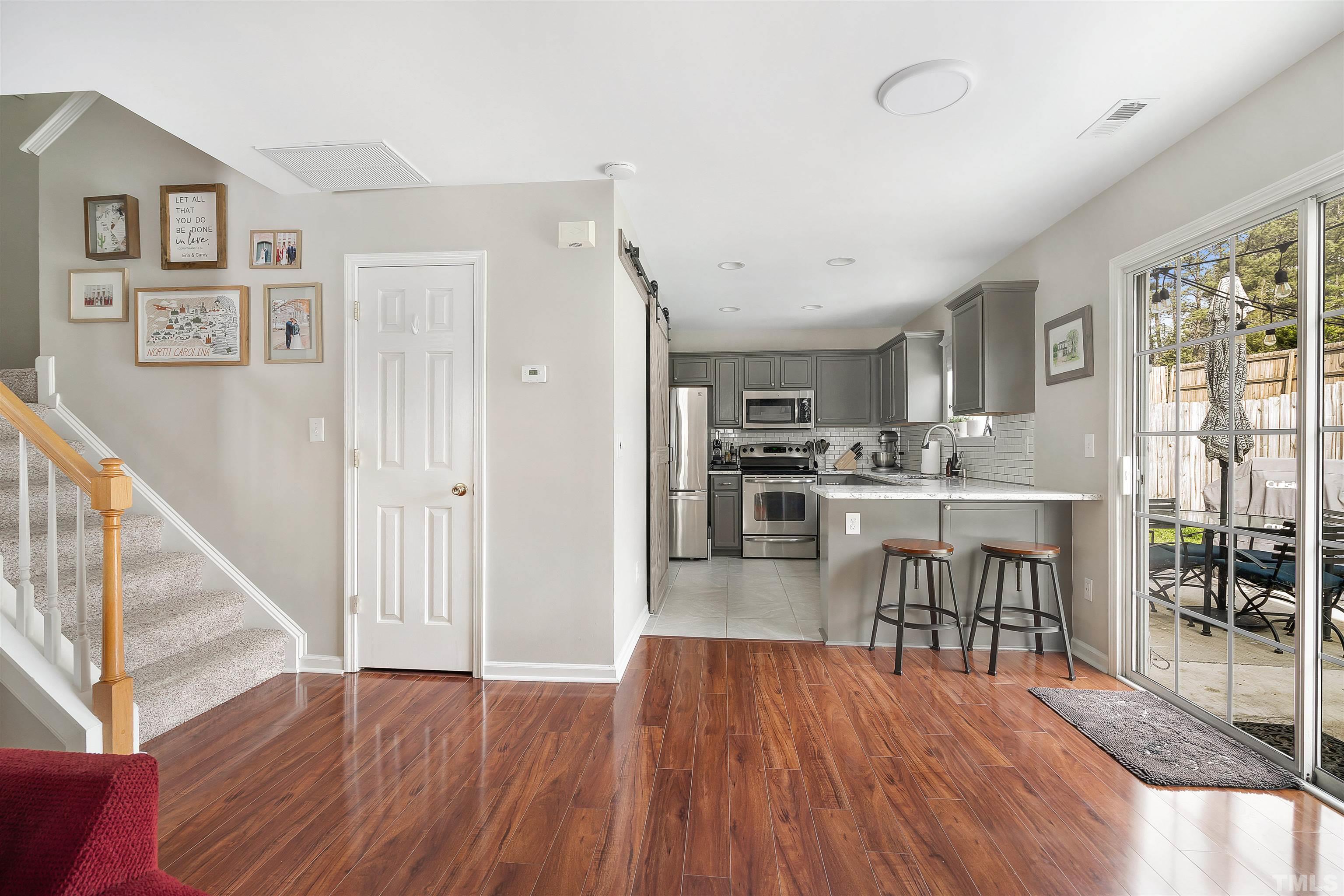 12440 North Exeter Way Durham, NC 27703 - Photo 11 of 36 a view of a dining room with furniture and wooden floor