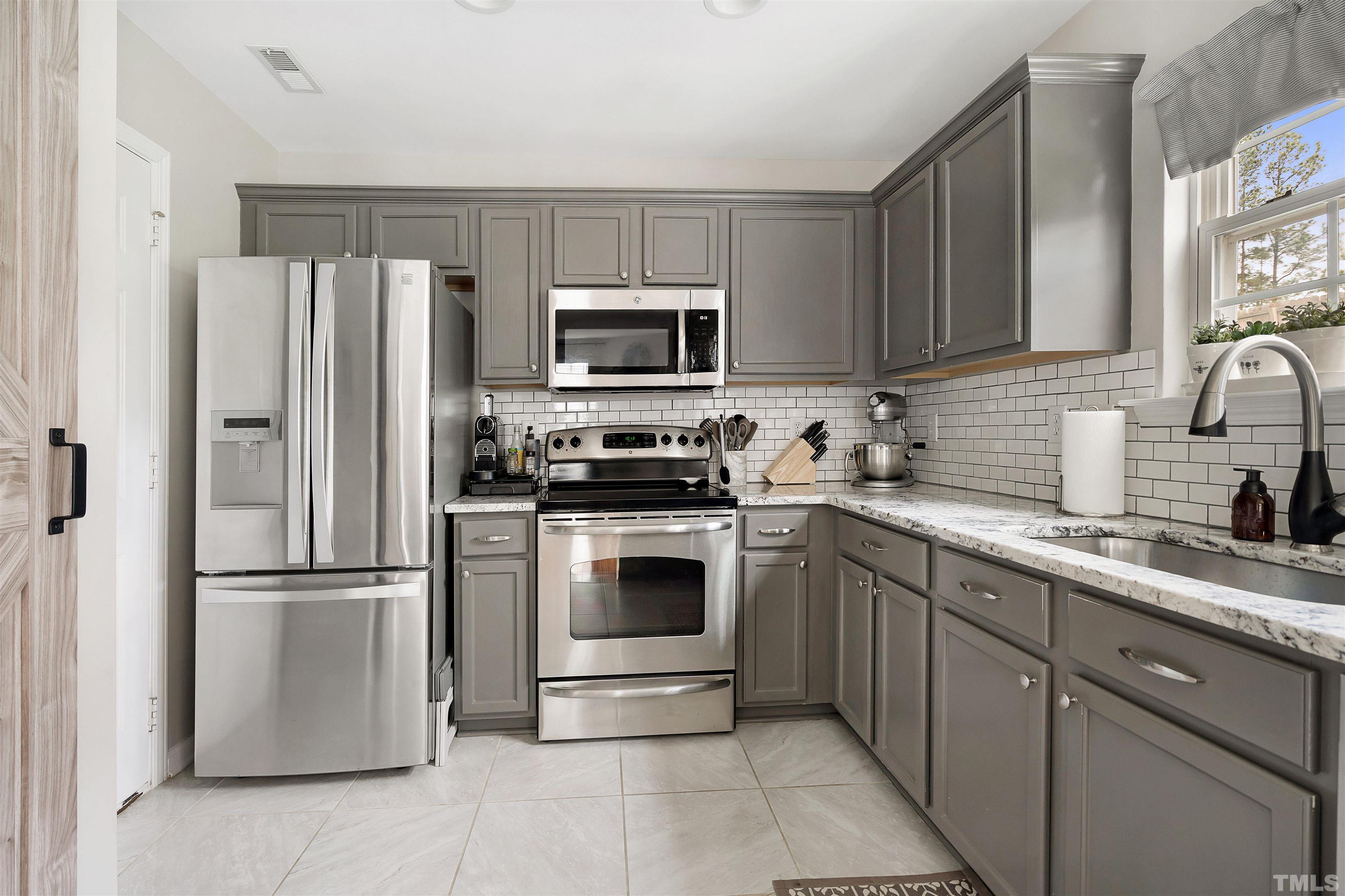 12440 North Exeter Way Durham, NC 27703 - Photo 16 of 36 a kitchen with a refrigerator sink and microwave